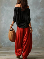 Elena | Top Nero Off-Shoulder e Pantaloni Lantern Rossi Svasati
